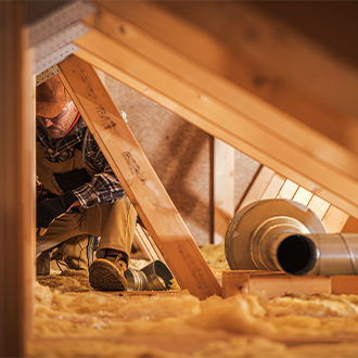 Man installing attic insulation.